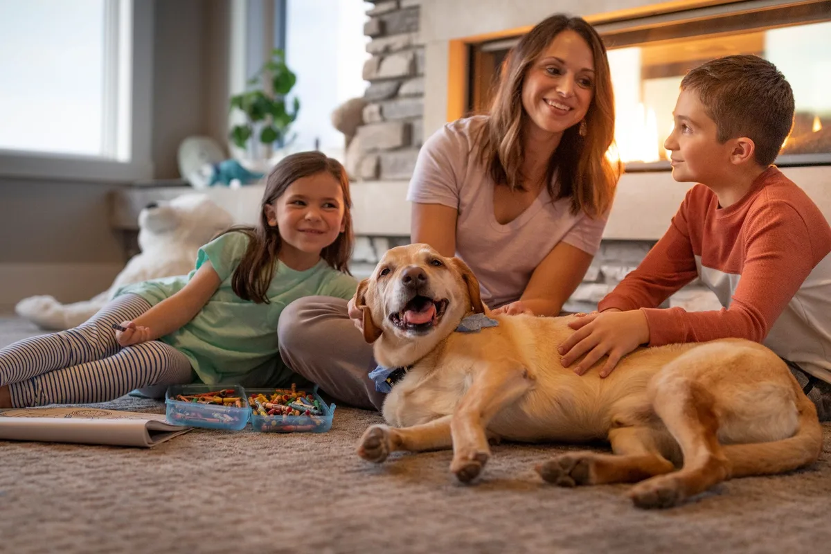 Family relaxing by a stone gas fireplace in their Tahoe home