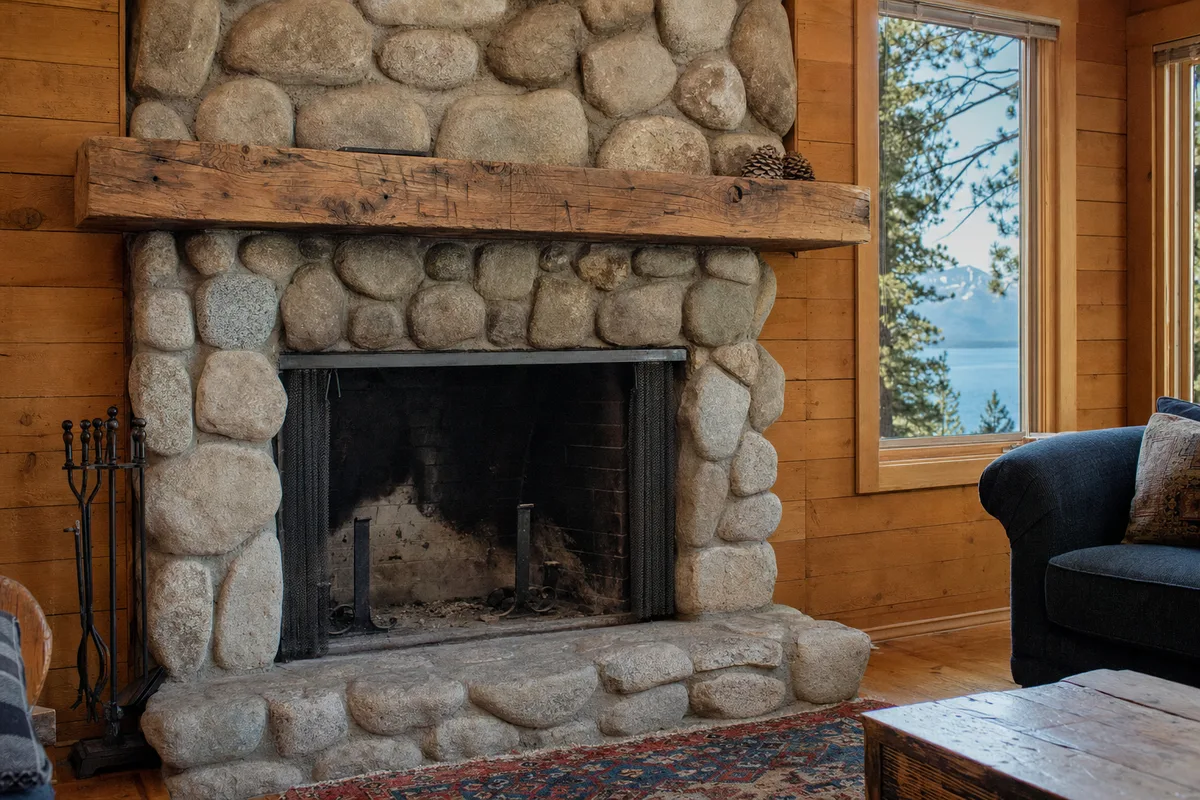 Older open masonry fireplace in a Tahoe cabin, ready for an insert