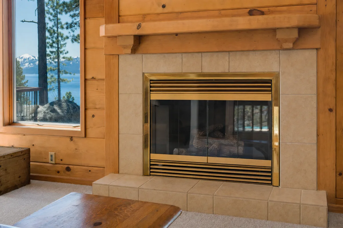 Dated brass-trim gas fireplace in a Tahoe home, ready for replacement